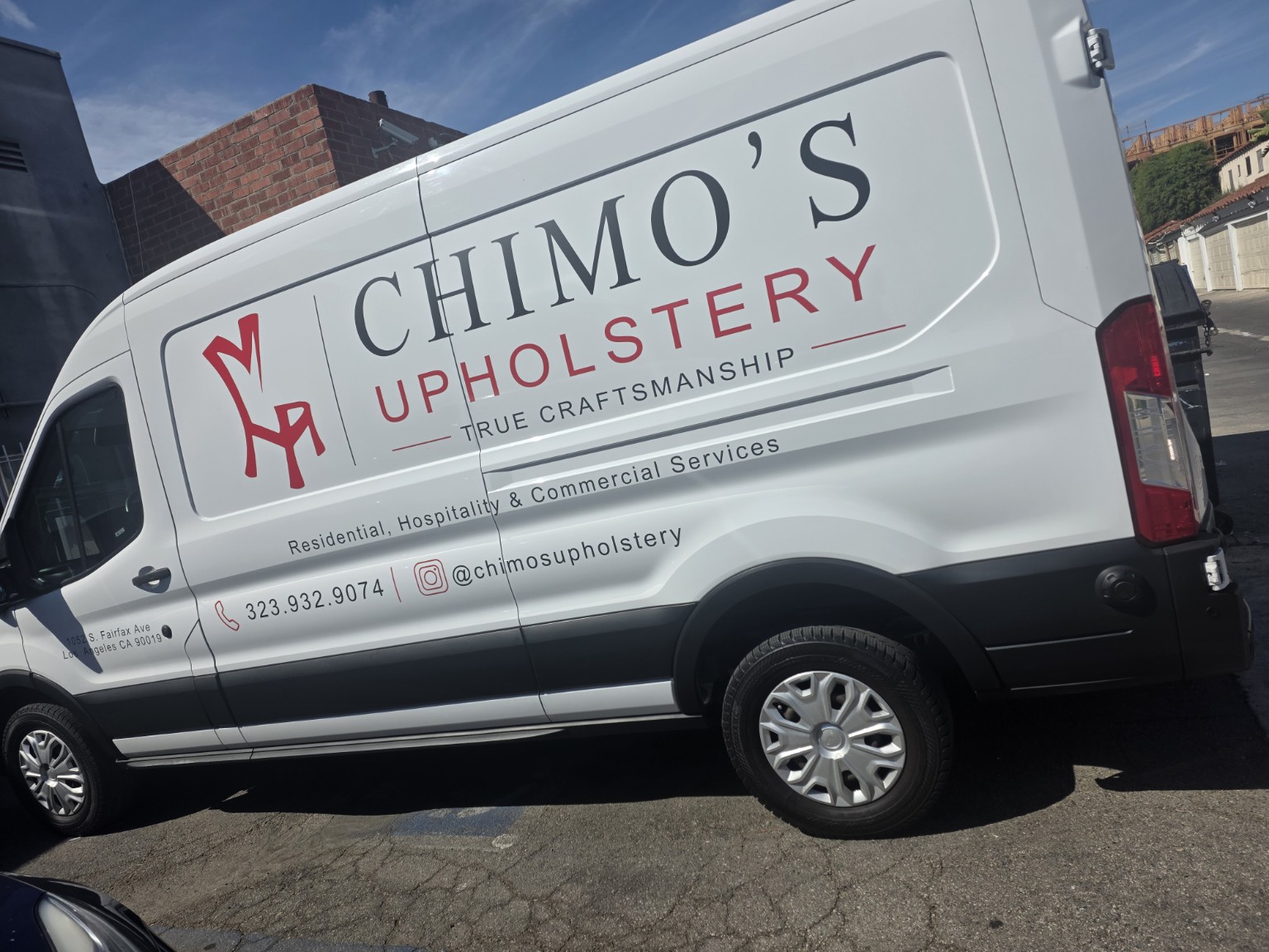 Commercial lettering and branding installed on a white cargo van