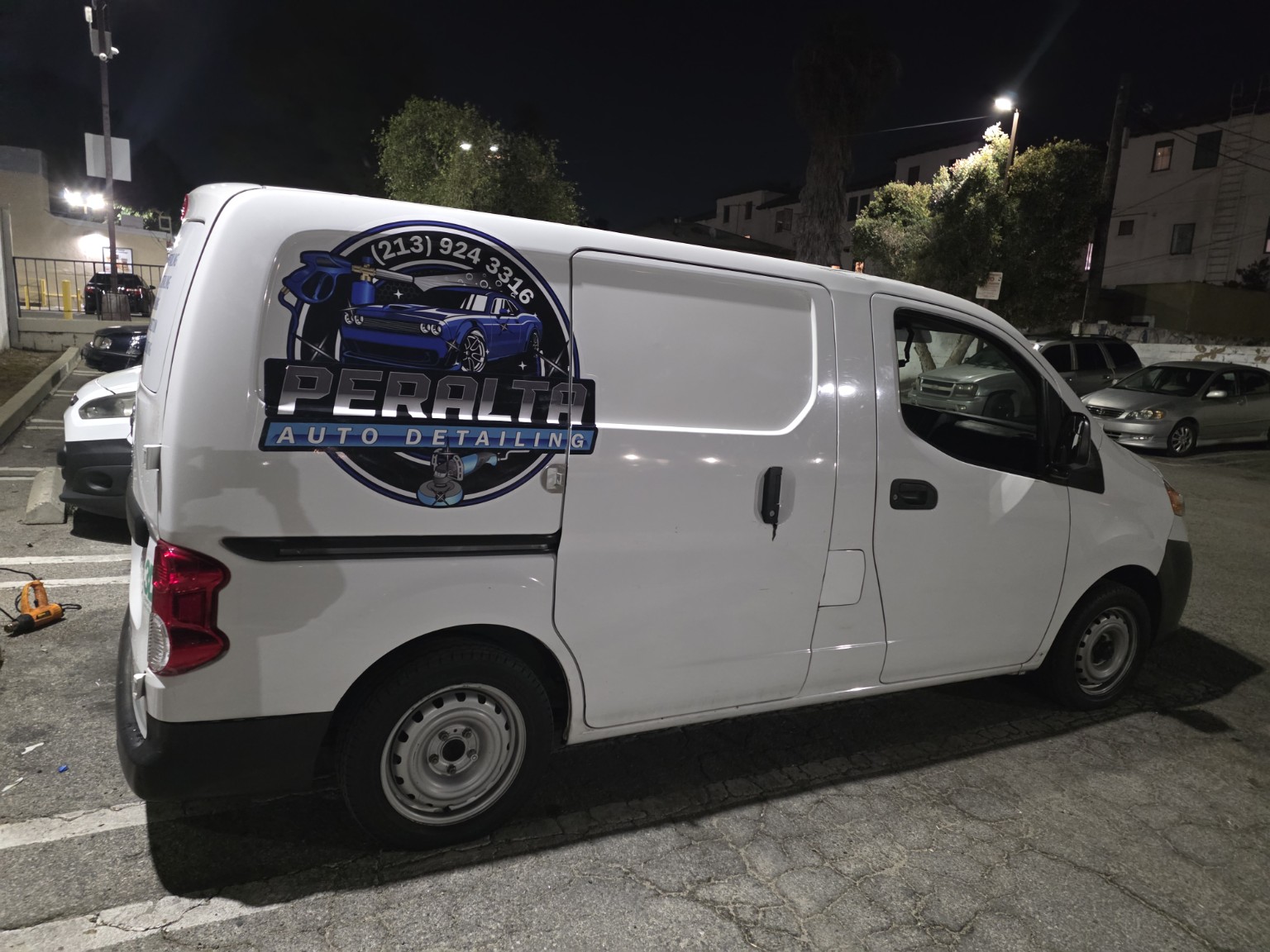 Custom auto detailing logo decal on a white van