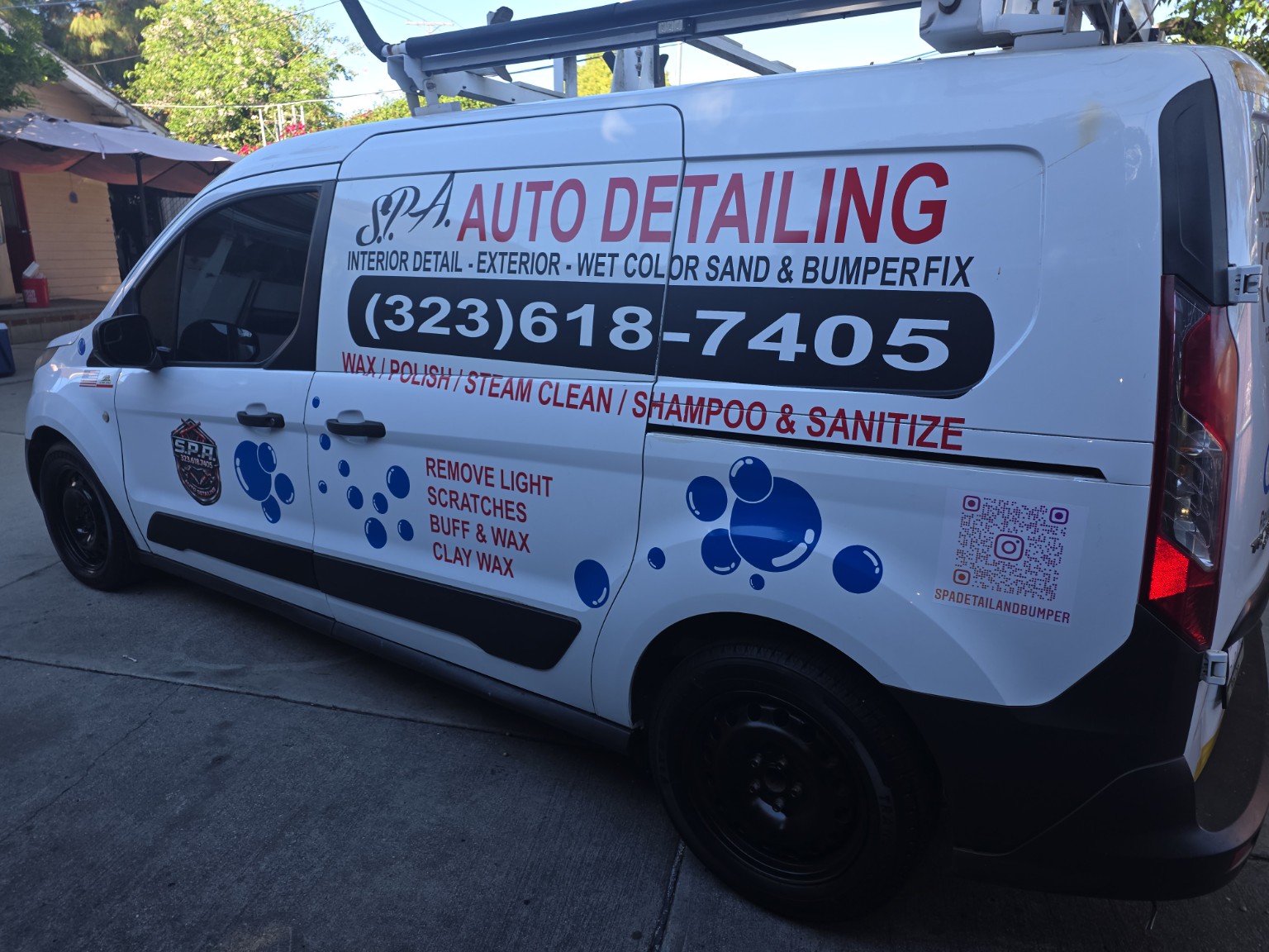 Auto detailing commercial decals installed on a service van