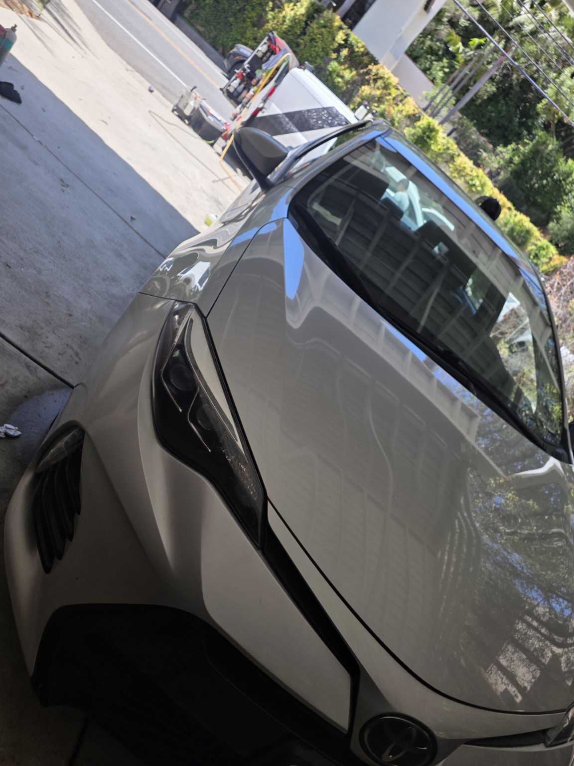 Mobile detailing service working on a white vehicle